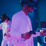 Entertainment Innovation - Man Playing a Video Game while Wearing a VR Headset