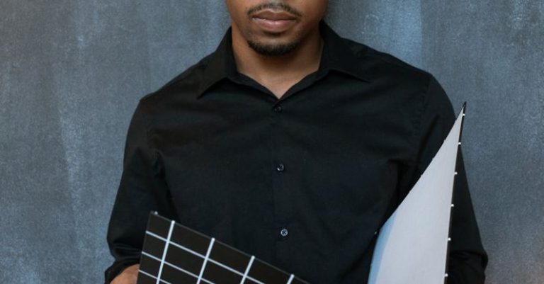 Actor Entrepreneur - Man in Black Dress Shirt Holding Blue and White Checked Textile
