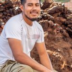Fintech Industry - A man squatting in front of a pile of dried fruit