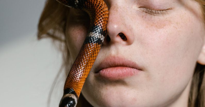 Overcoming Adversity - Close-Up Photo of a Woman Overcoming Her Fear of Snakes