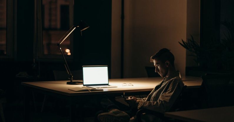 Online Success - Man in Black and White Stripe Dress Shirt Sitting on Chair in Front of Macbook