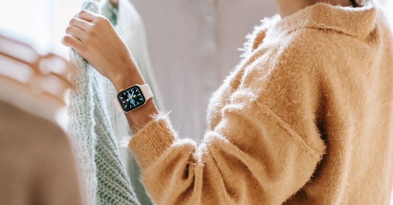 Customer Centric - Back view of unrecognizable dark haired female in jeans choosing clothes near rack