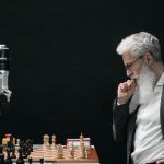 Strategic Alliance - Elderly Man Thinking while Looking at a Chessboard
