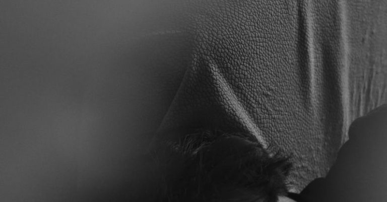 Sleep Optimization - A woman laying on her back with her head in the air