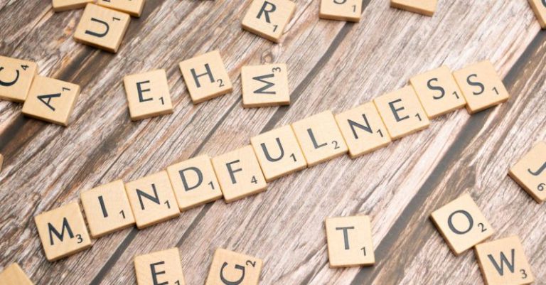 Mindful Living - The word mindfulness spelled out with scrabble tiles