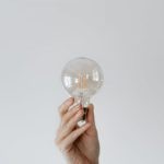 Creative Innovation - Anonymous female showing light bulb